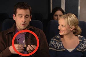 A couple sitting on an airplane with a man holding headphones, which is circled for emphasis