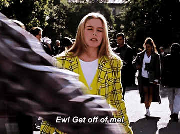 Cher Horowitz from Clueless in a plaid jacket, pushing someone off of her and saying &quot;Ew! Get off of me!&quot;