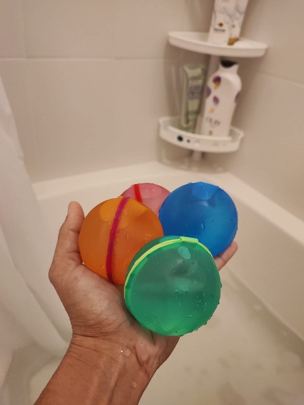Hand holding 4  of the bath bombs