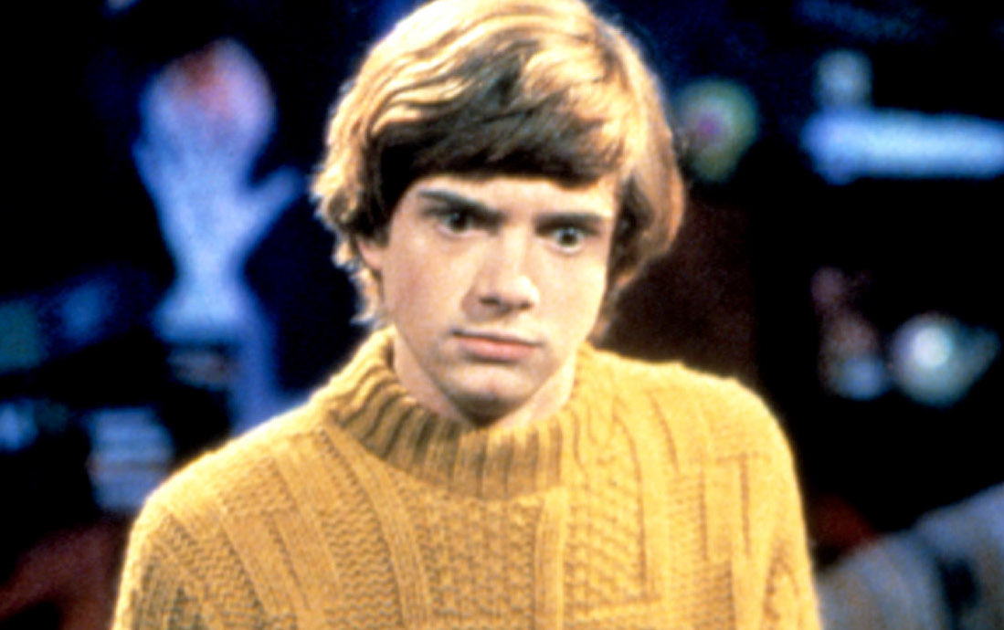 Elsa from Frozen is not present in this image, and the image does not include a celebrity that I can name. The image features a character from a TV show or movie wearing a ribbed sweater