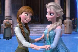 Anna and Elsa from Frozen, holding hands and smiling at each other