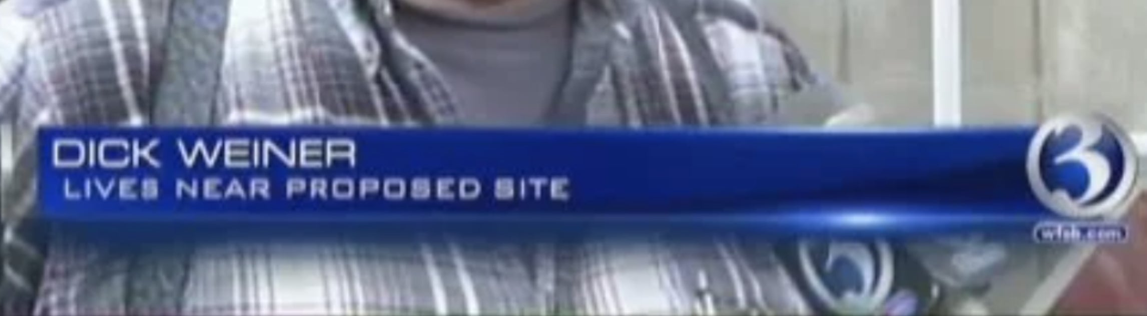 Man in a cap and plaid shirt being interviewed with a lower-third graphic displaying his name and caption, "Lives near proposed site"