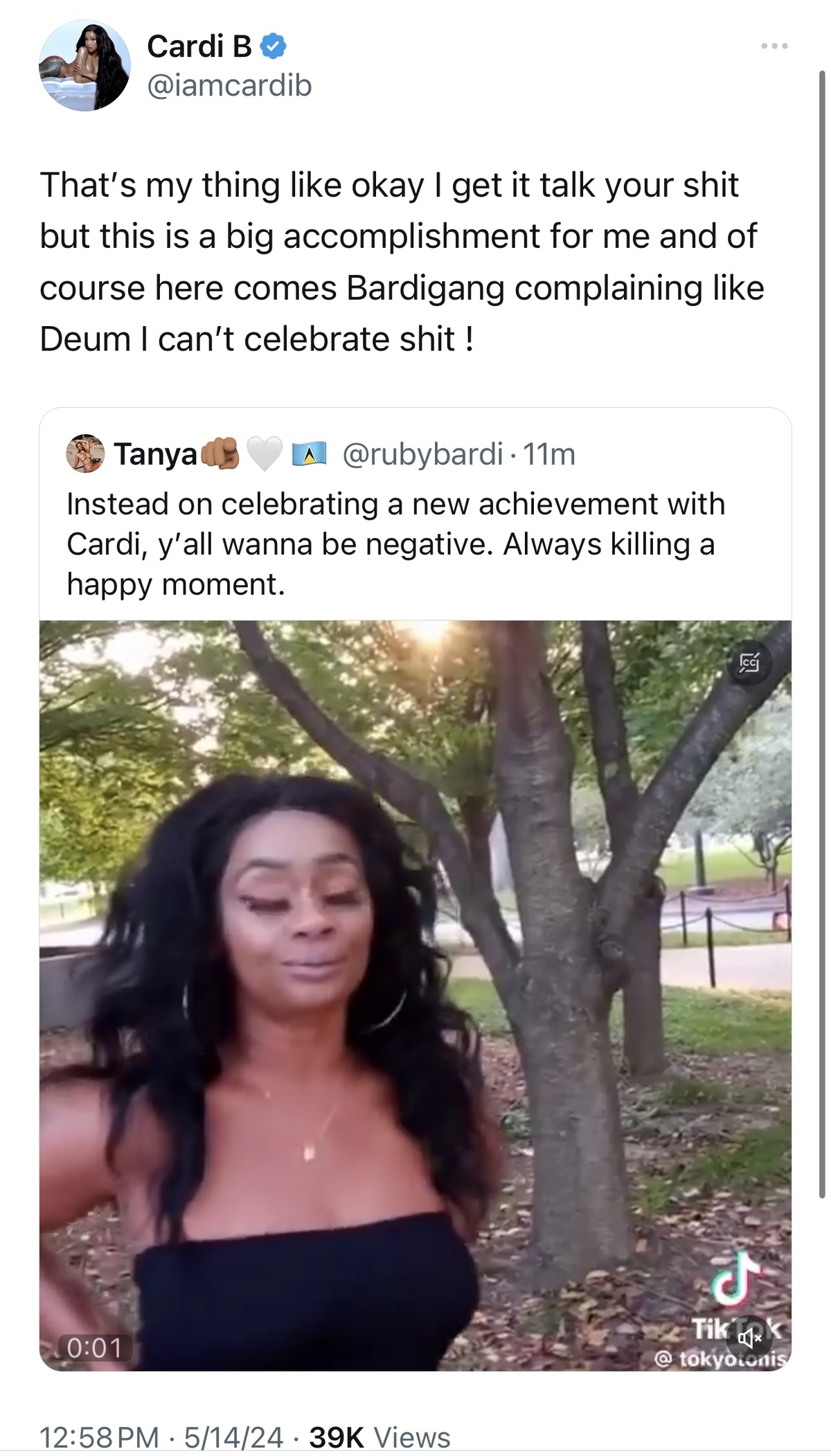 Cardi B in a video expressing frustration with a negative comment on a celebratory post