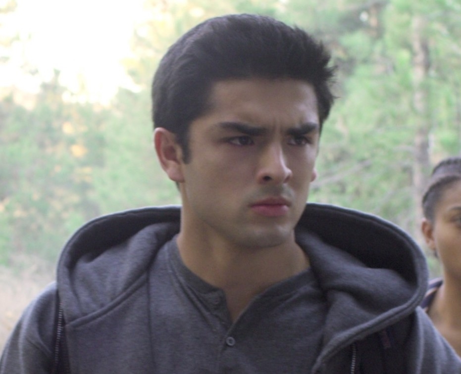 Man with furrowed brows in a gray hoodie, appears pensive or concerned