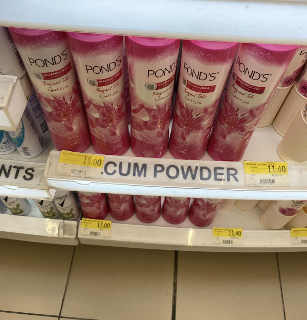 Shelf with POND'S products and a misprinted label reading "CUM POWDER" instead of "TALCUM POWDER"