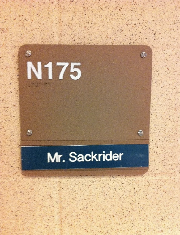 Room sign reading "N175" with the name "Mr. Sackrider" displayed below
