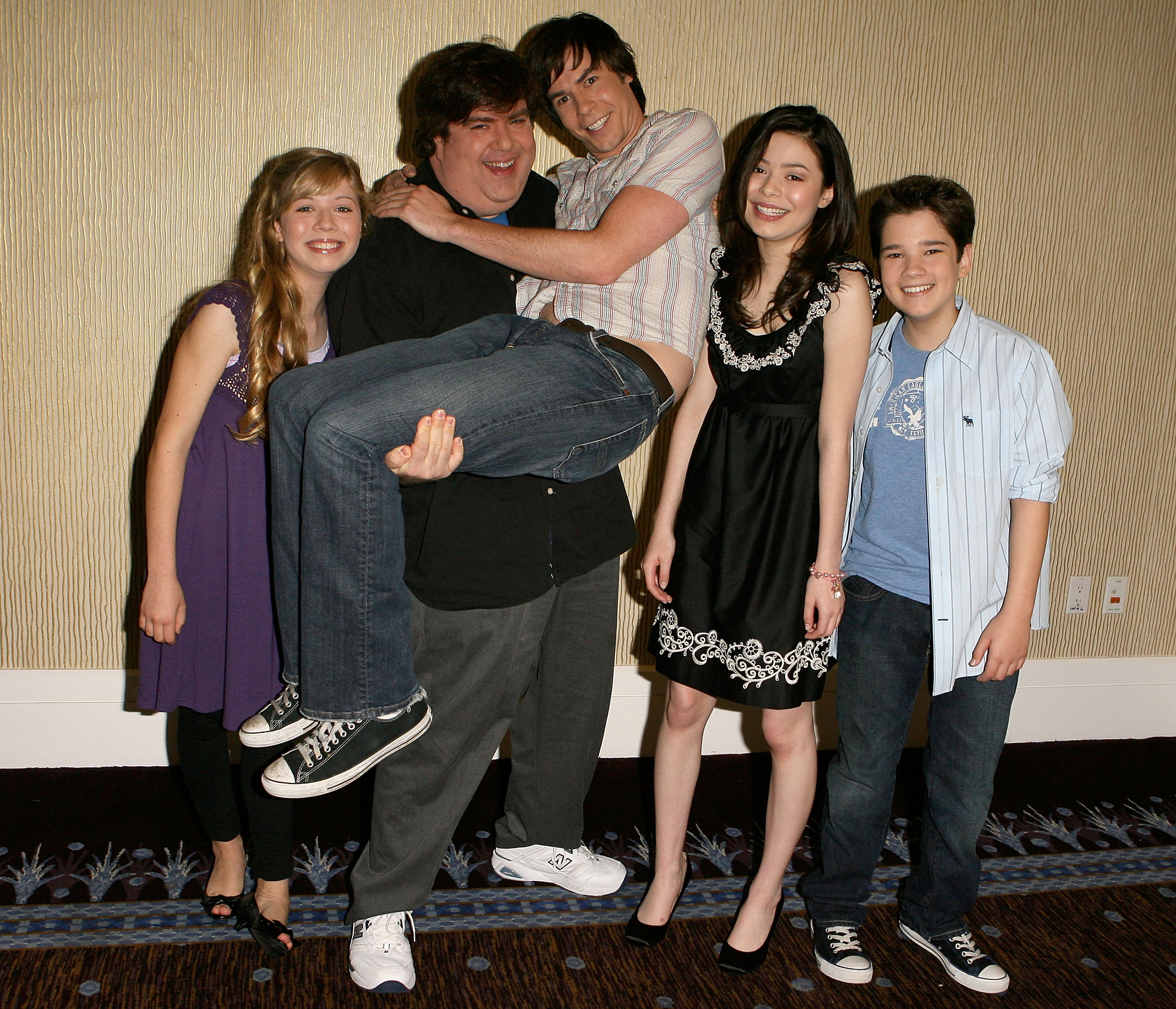 Dan Schneider with the cast of &quot;iCarly&quot; carrying one of the male cast members