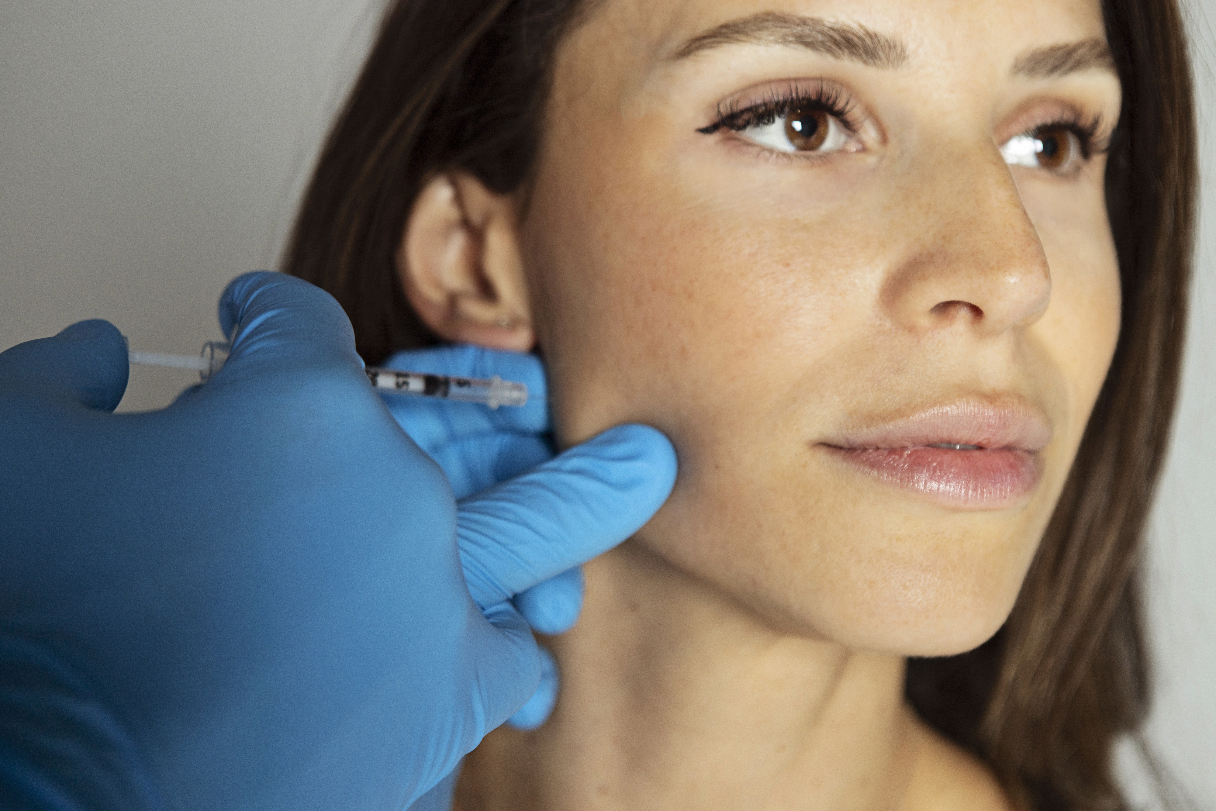 Woman receiving a facial injection, focusing on wellness and self-care