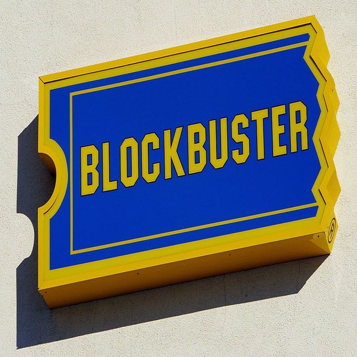 Blockbuster sign on a wall, indicative of the video rental store chain popular in the 90s and early 2000s
