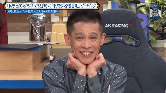 テレビ番組に出演している笑顔の男性タレント。