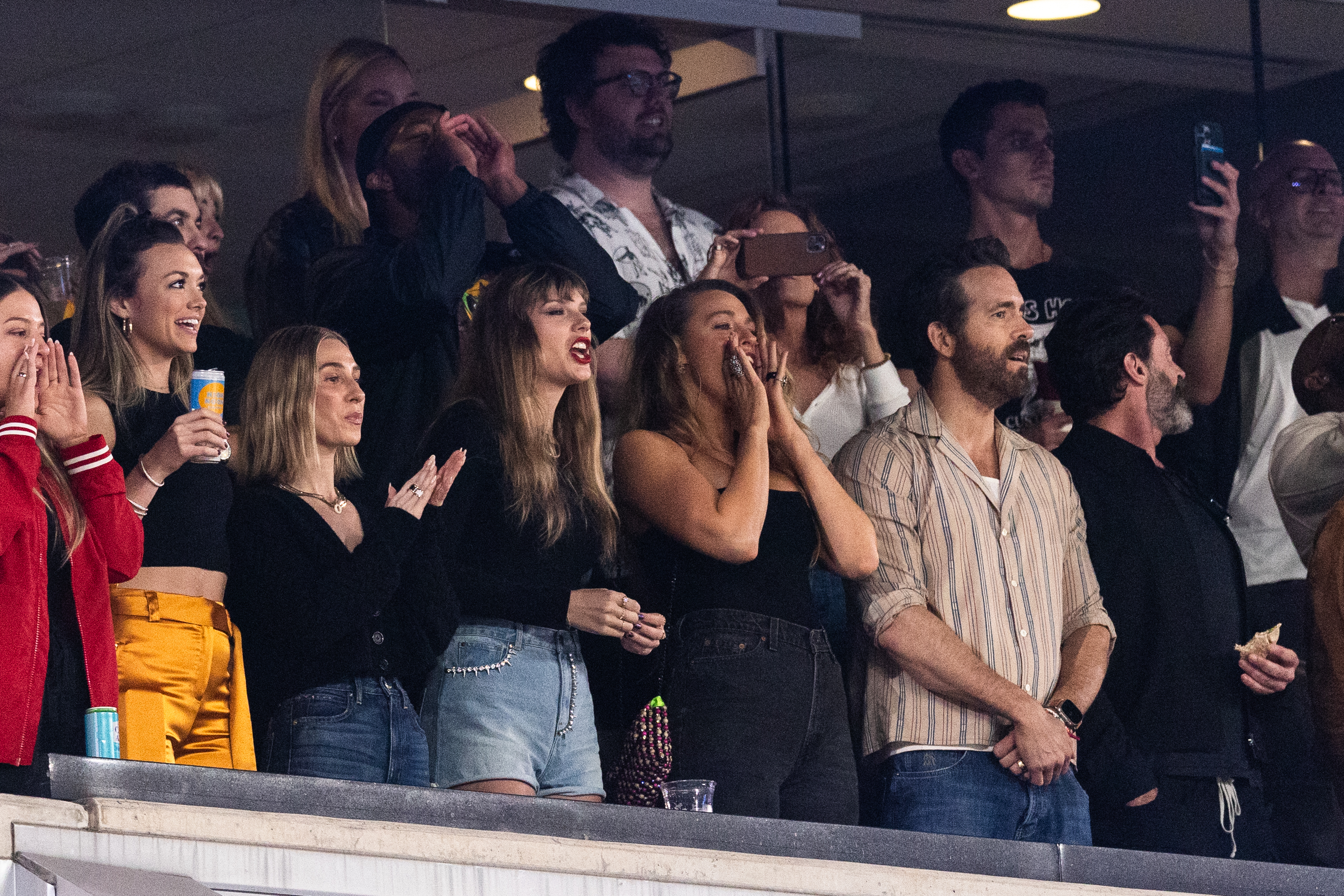 Taylor Swift, Blake Lively, Ryan Reynolds cheering at an event
