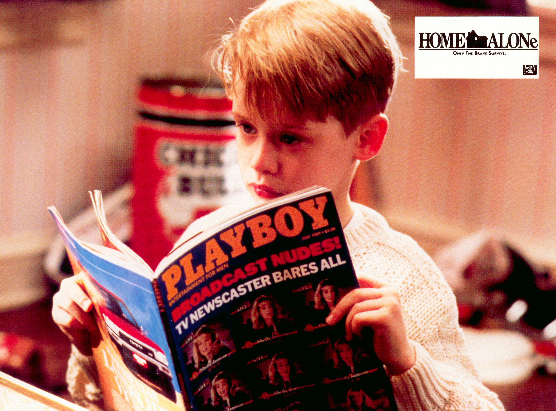 Child actor in &quot;Home Alone&quot; looks at a magazine. The scene invokes a classic moment from the film