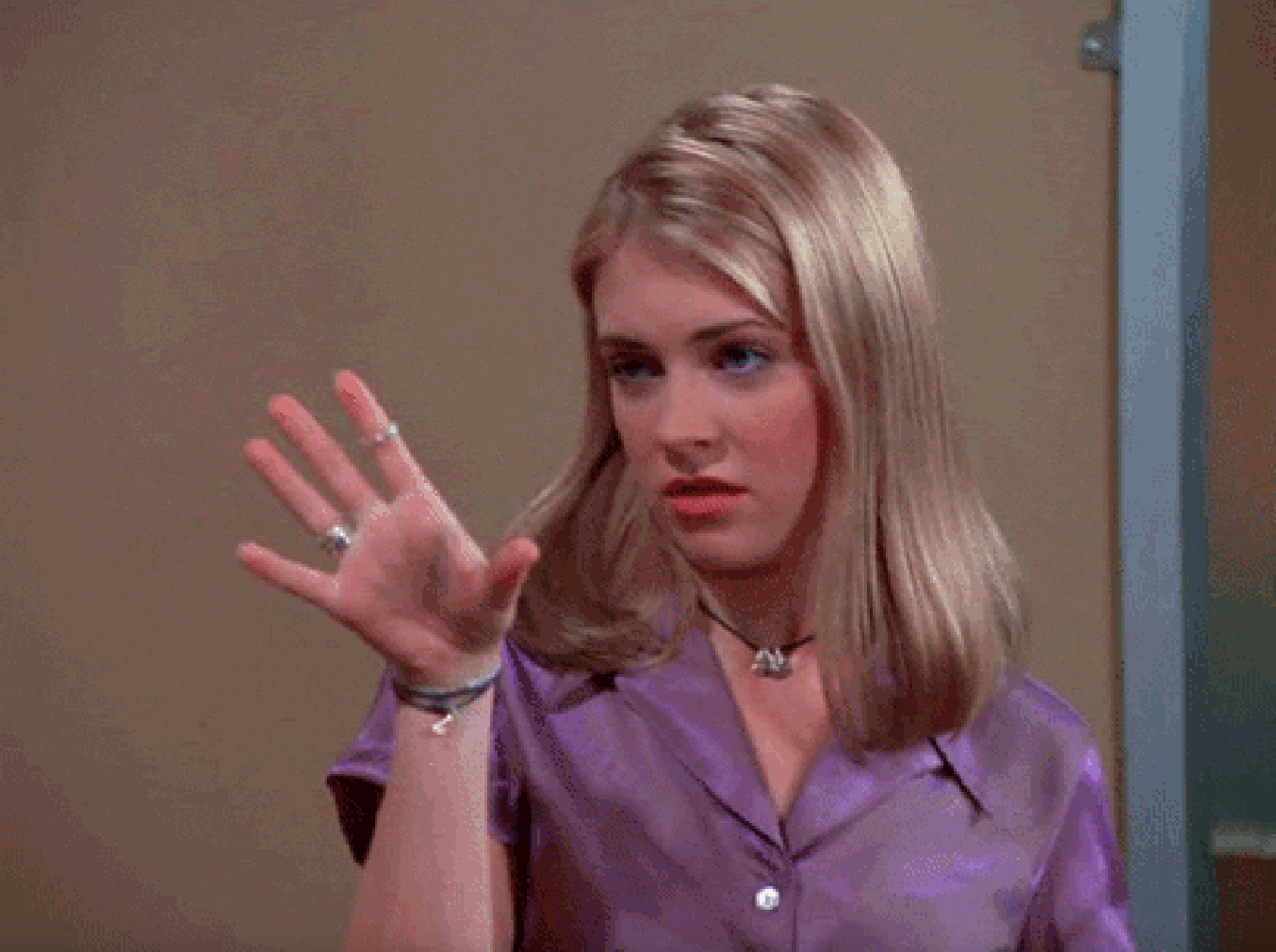 Woman gestures with her hand, portraying Kelly Bundy from &quot;Married&hellip; with Children&quot;