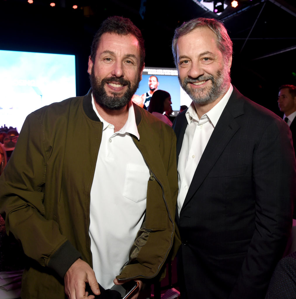 Two men posing for the camera; one in a green jacket and white shirt, the other in a grey blazer and matching shirt