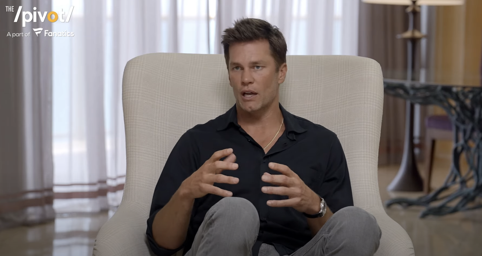 Tom Brady, seated, gestures while speaking in an interview setting for &quot;The Pivot&quot;