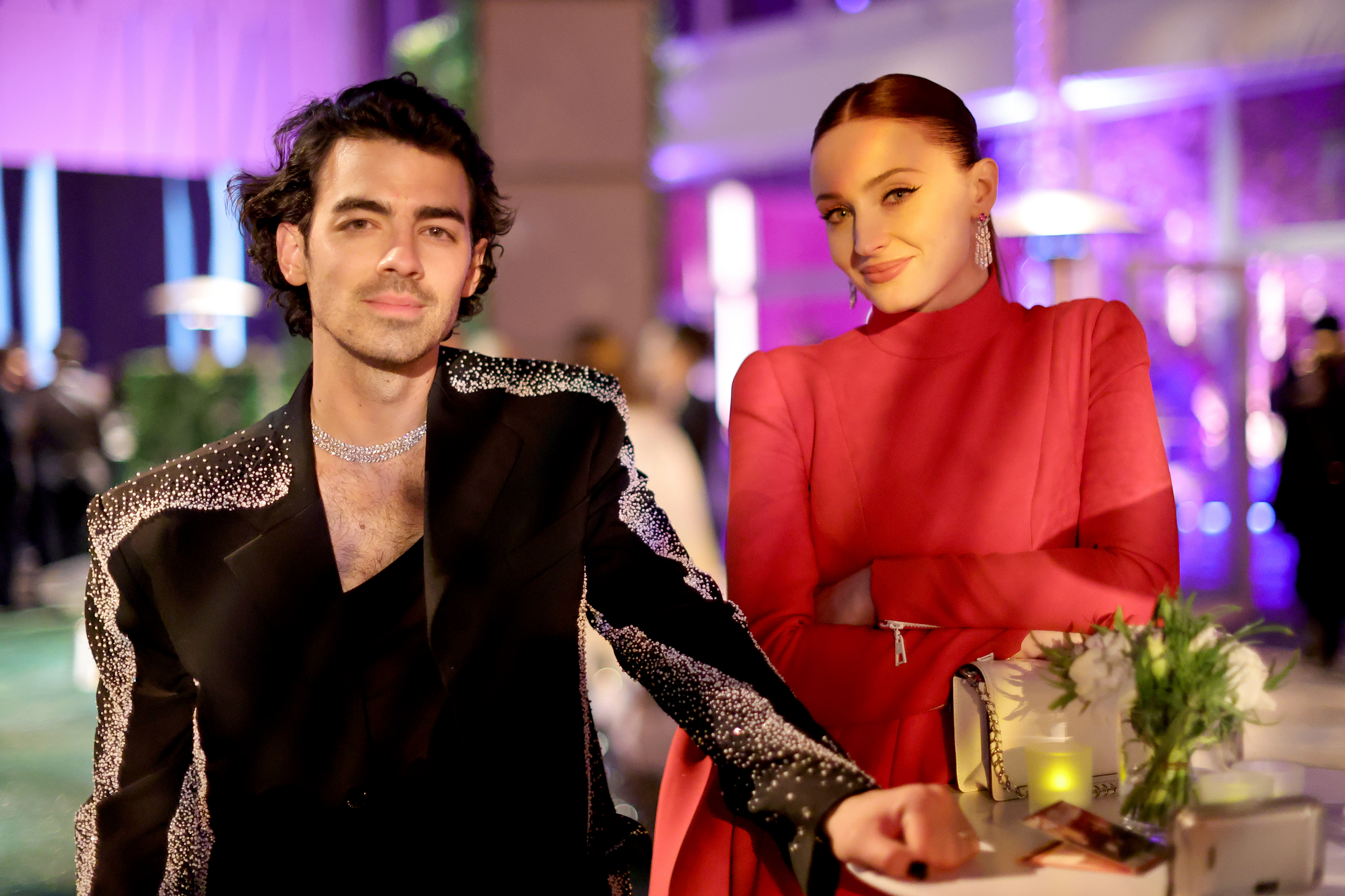 Joe Jonas and Sophie Turner seated at an event