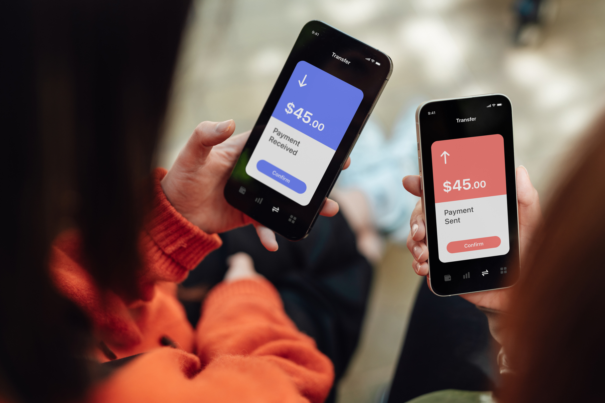 Two hands holding smartphones, screens showing a $45 payment sent and received via a mobile app