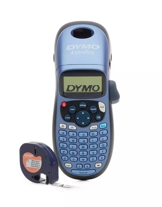 Handheld DYMO Letratag label maker and tape next to it