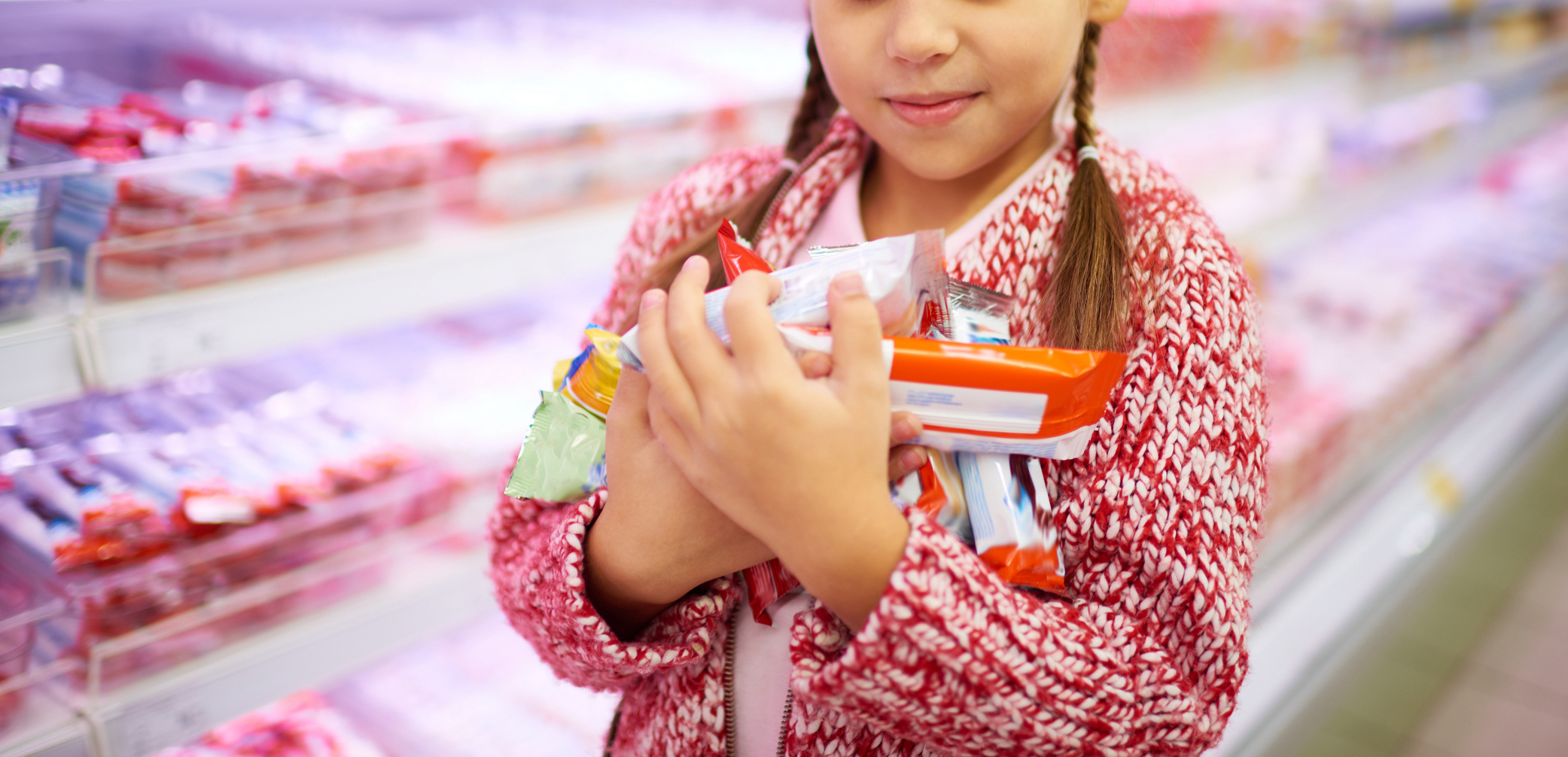 Young girl holding a lot of candy