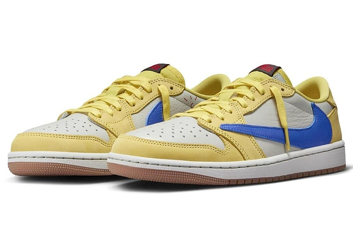 Pair of yellow and blue sneakers with white laces on a white background