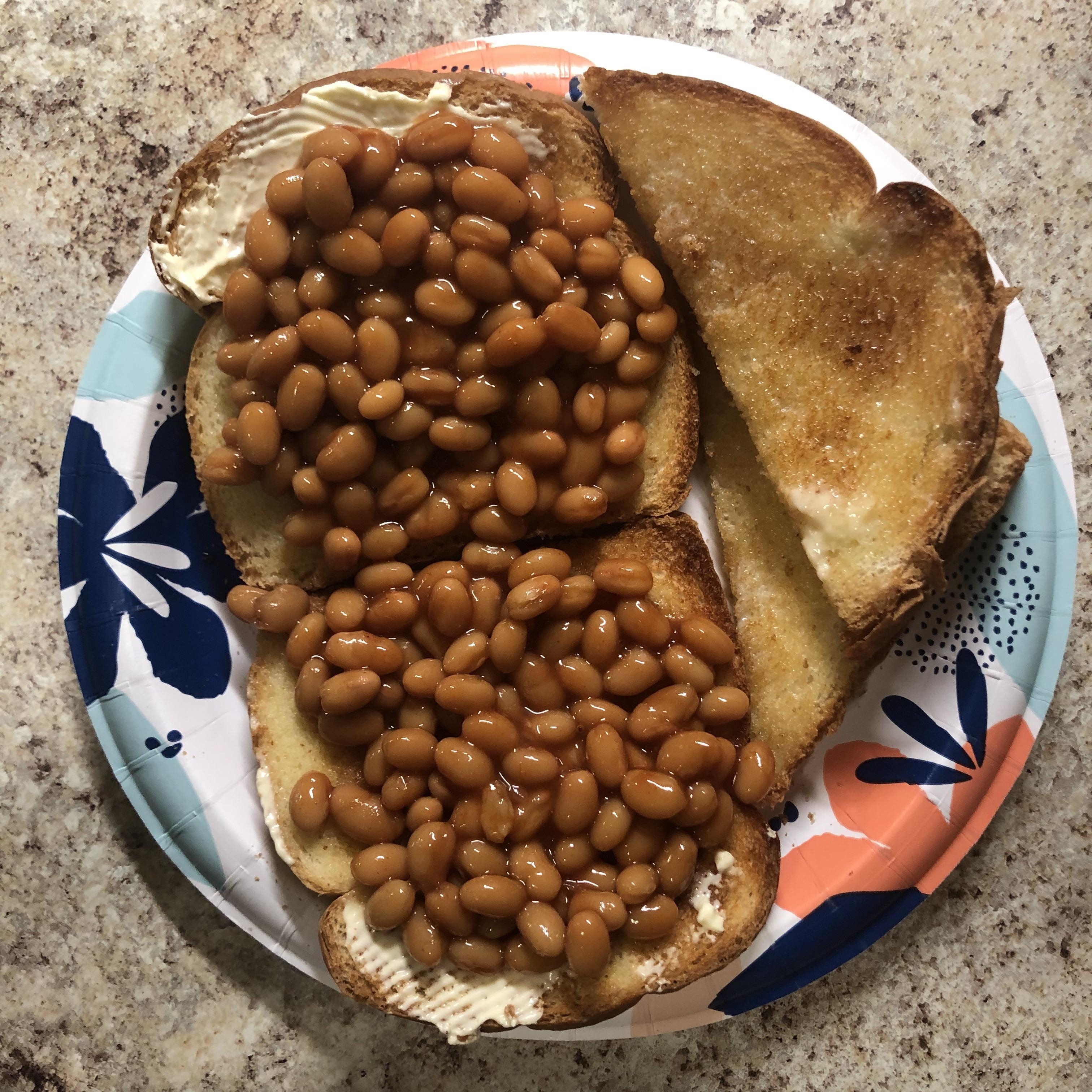 A plate with toast covered in baked beans