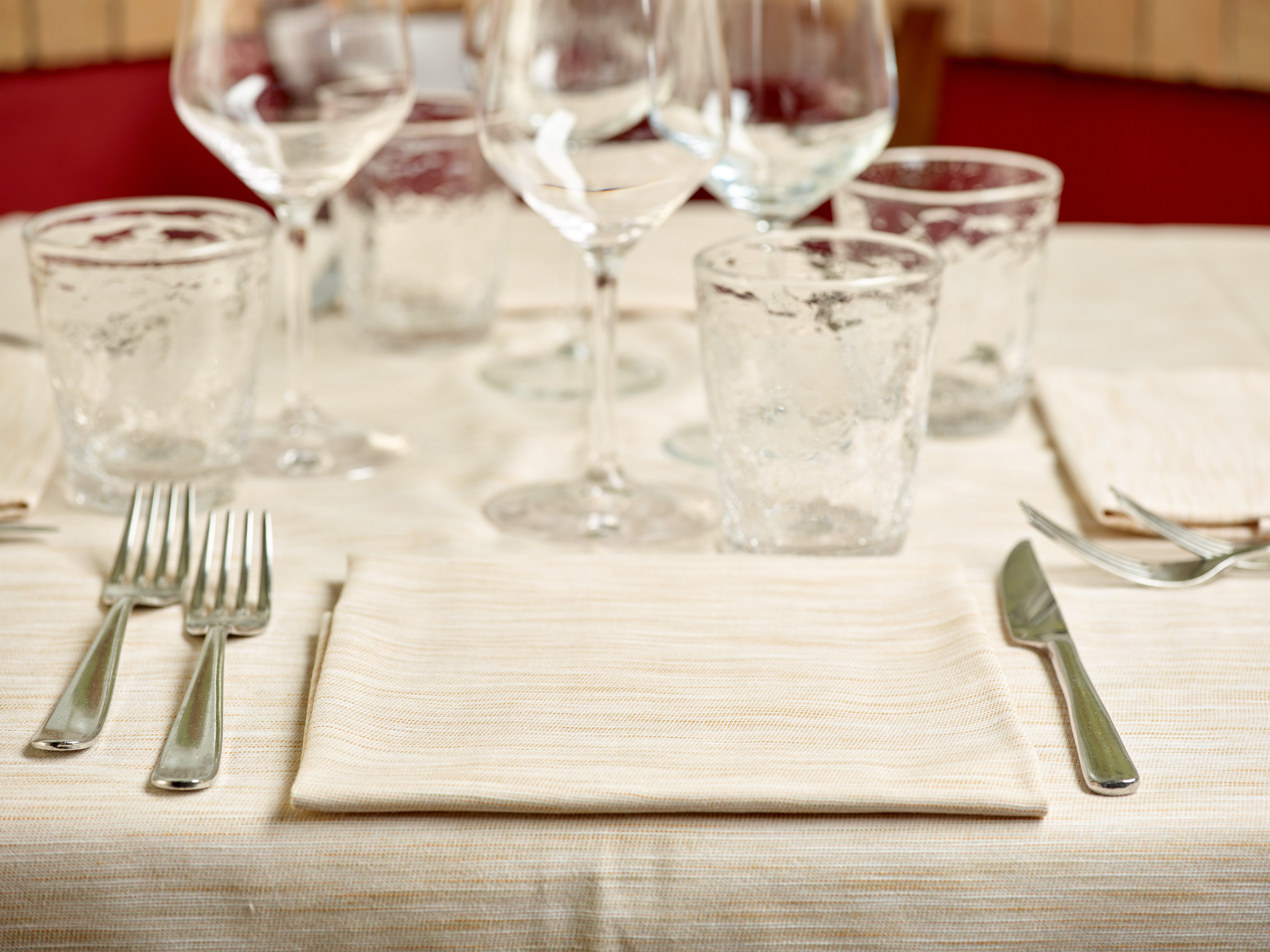 Elegant table setting with glassware and utensils for a formal dining experience