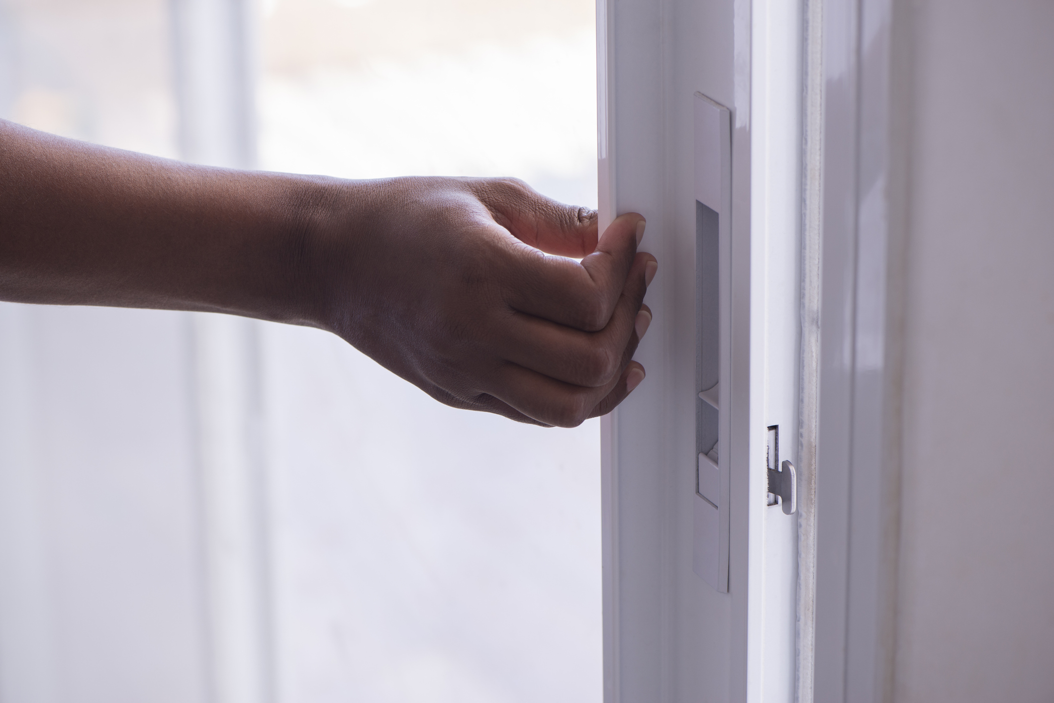 Close-up of a person's hand turning on a light switch
