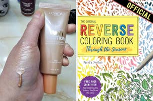 Hand holding L'Oreal Infallible foundation tube with product swatched on thumb; book titled "The Original REVERSE COLORING BOOK" visible