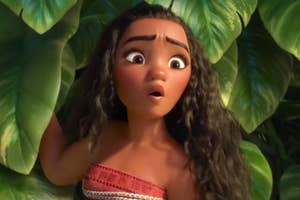Moana appears surprised amidst tropical foliage in a scene from the film