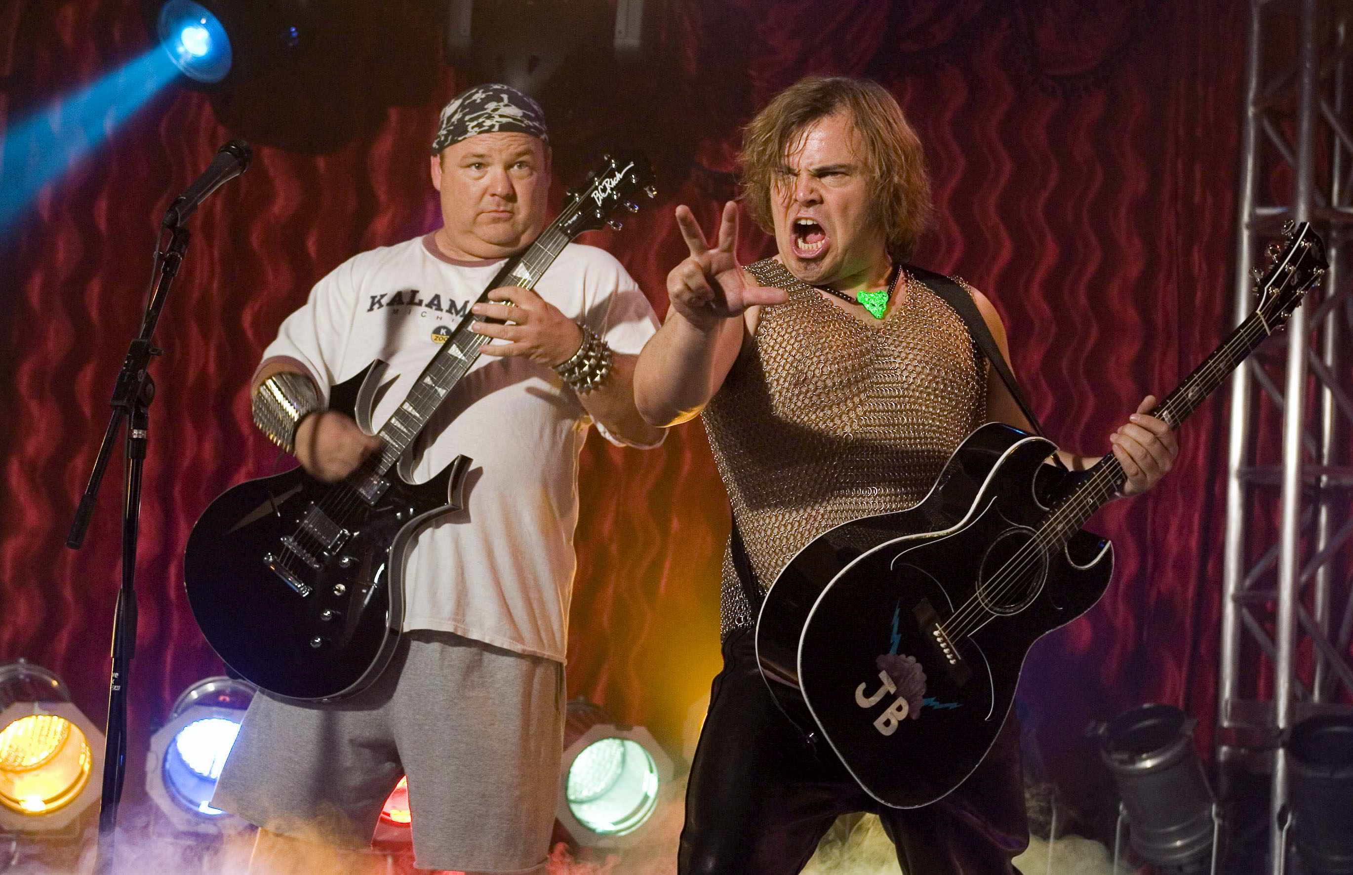 Jack Black and Kyle Gass of Tenacious D perform on stage with guitars