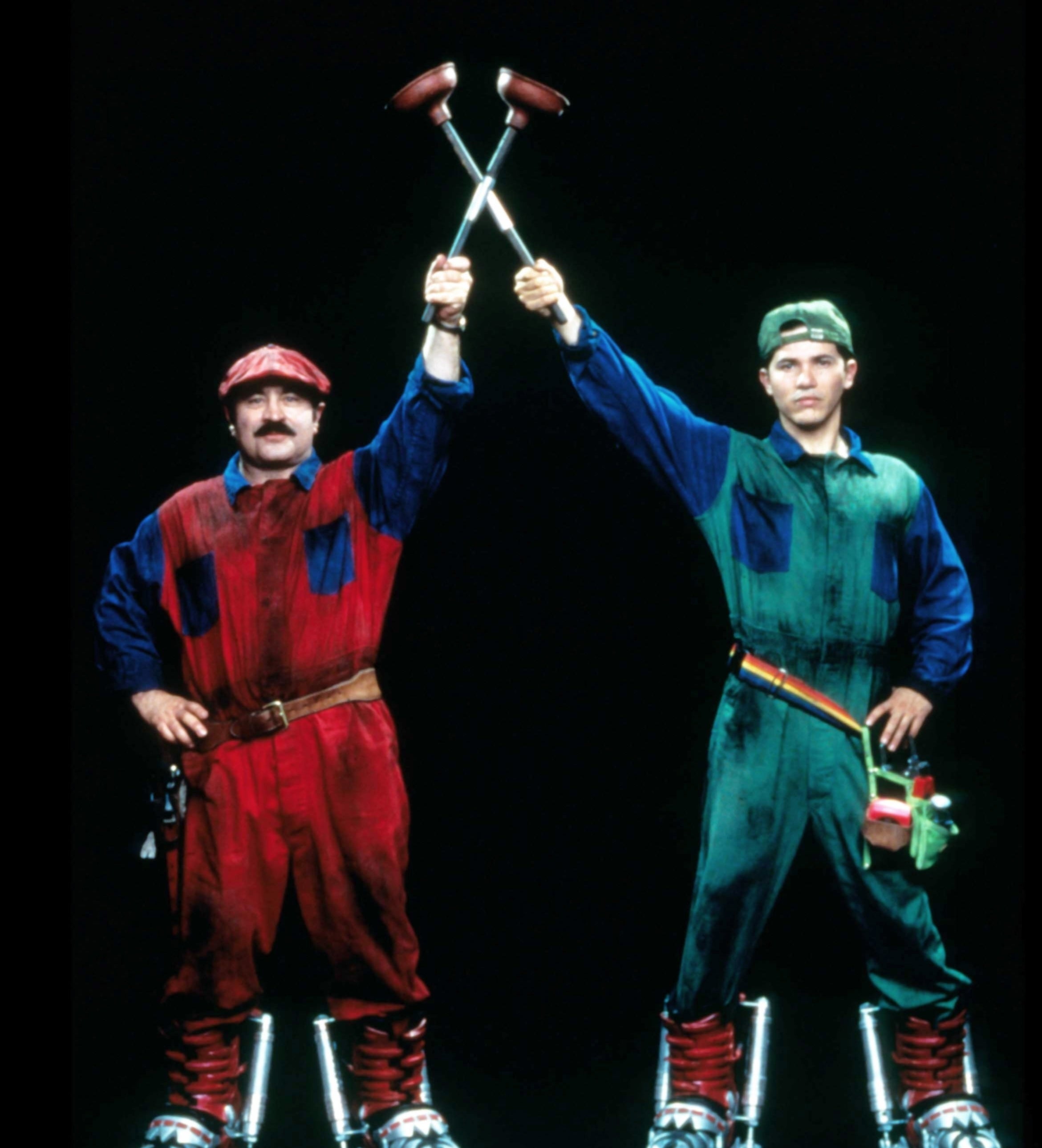 Mario and Luigi from the Super Mario Bros film, wearing their iconic costumes and holding plumber tools
