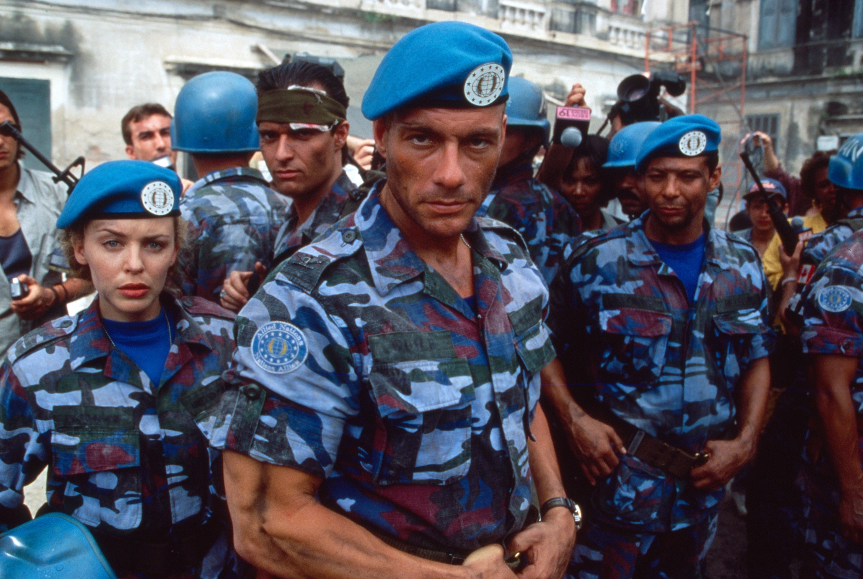 Jean-Claude Van Damme in military attire with extras in &quot;Street Fighter&quot; film