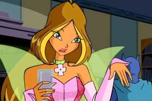 Animated character Flora from Winx Club with wings and holding a glass, in a library setting
