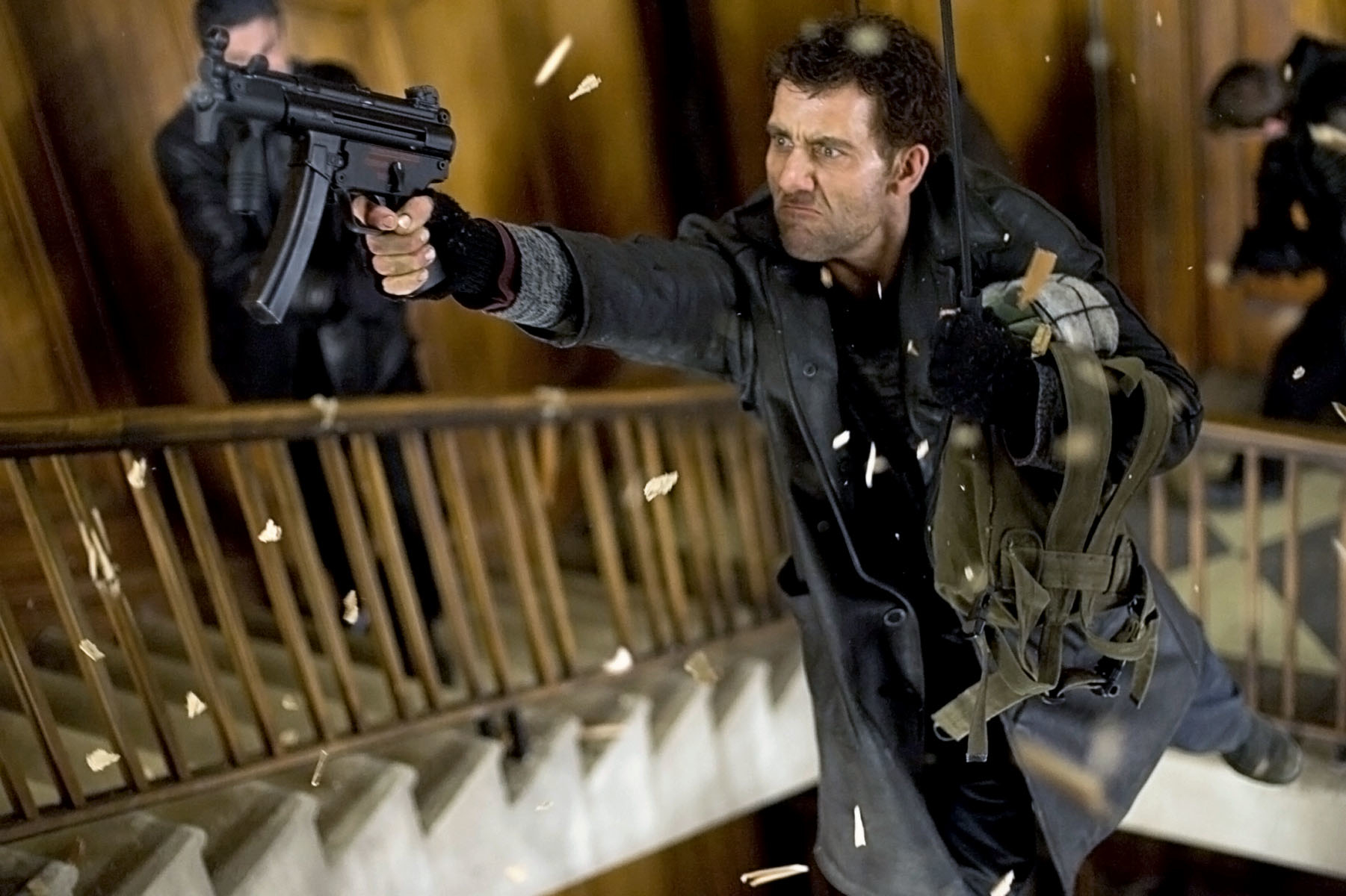 Man in action pose with gun, police in background, in intense movie scene