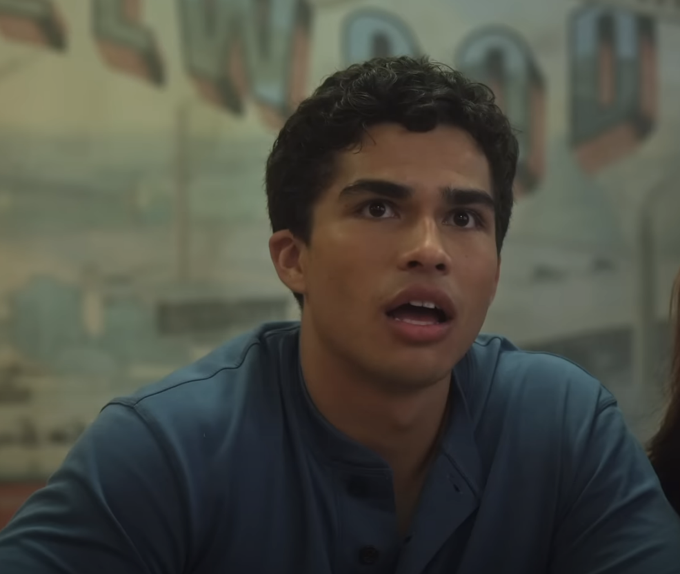 Man in a blue shirt looks surprised or concerned