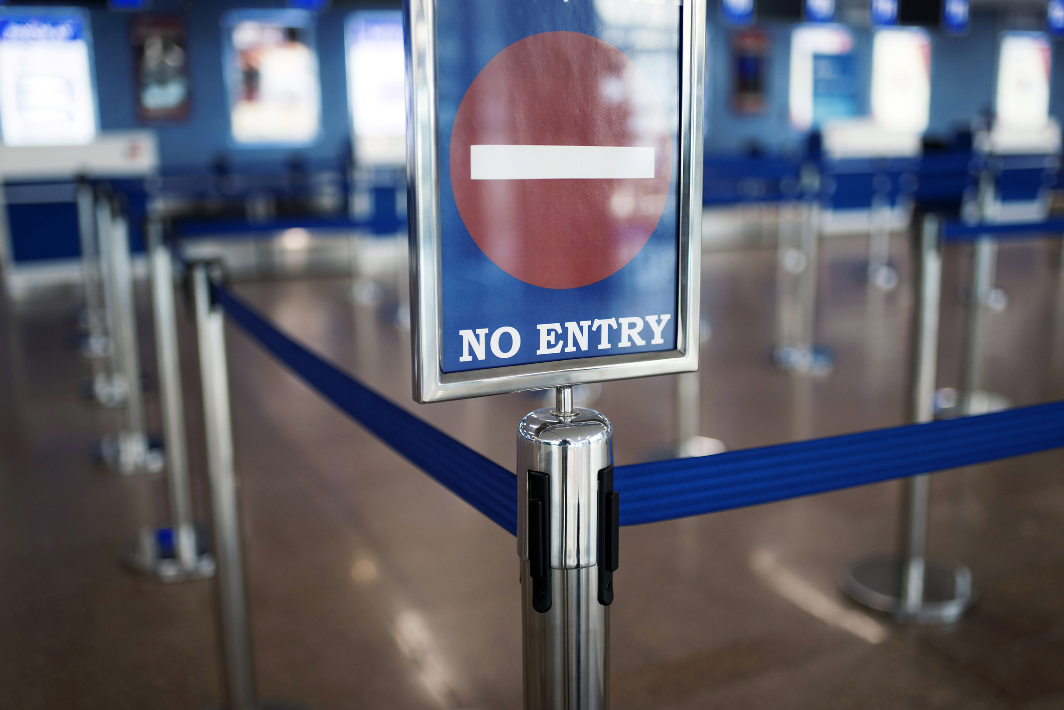 No Entry sign on a stanchion with retractable belts at a queuing area