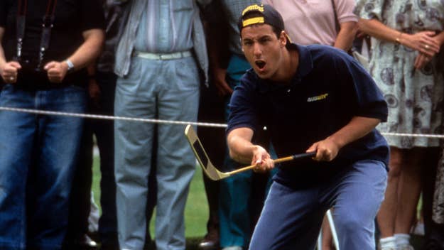 Adam Sandler in 'Happy Gilmore' wearing a blue t-shirt and khakis, doing a hockey-style golf swing