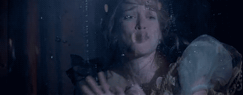 A magician's assistant struggles to breathe in a water tank