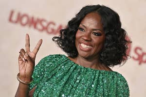Viola Davis in a sequined dress, smiling and gesturing a peace sign