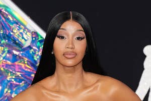 Cardi B on the red carpet in a metallic gown with a strapless bodice