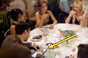 Scene from Friends with characters Monica, Ross, and Rachel at a dinner table, while Ross's hand is in focus in front