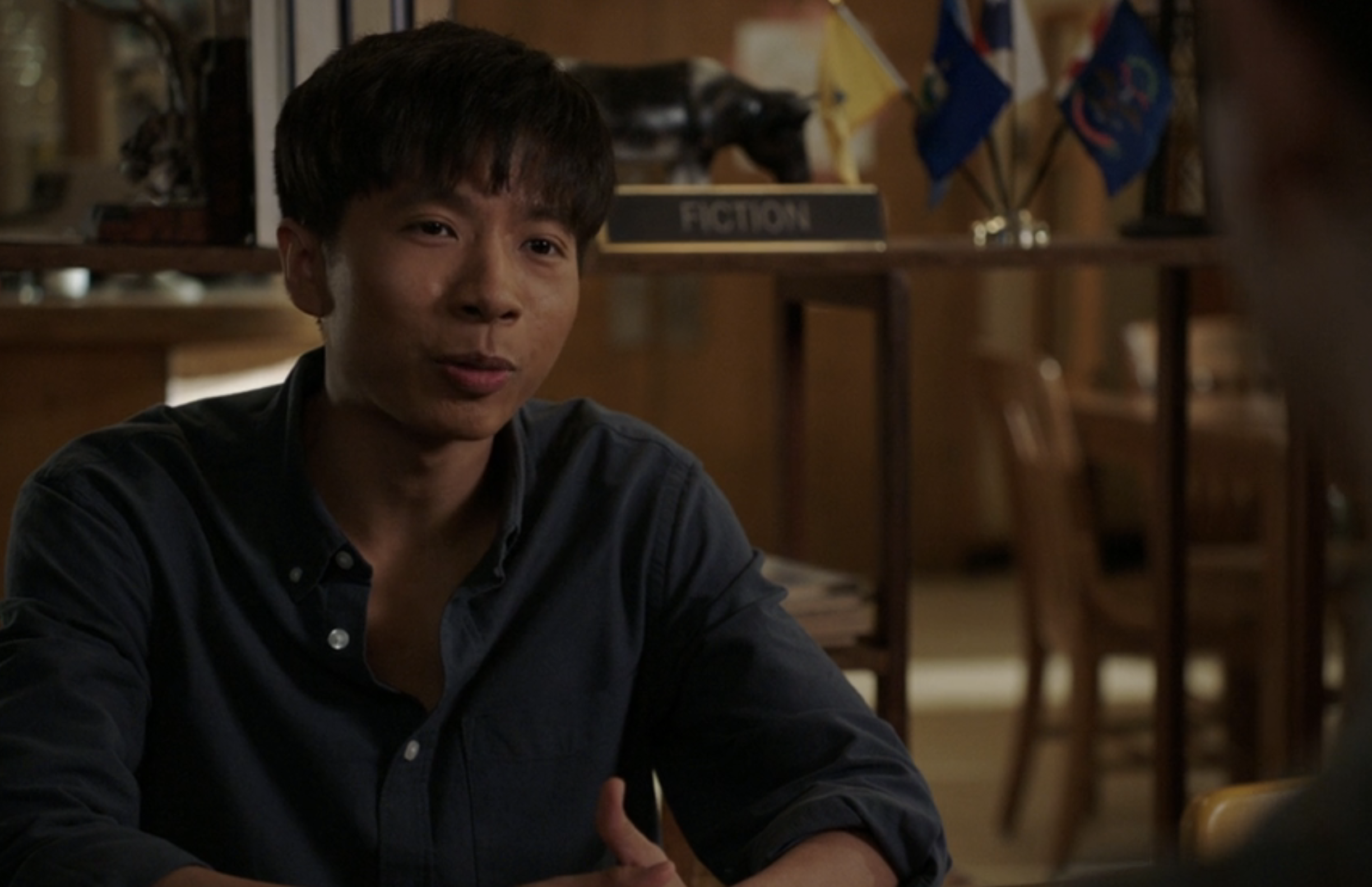 Tam in a solid polo, unbuttoned