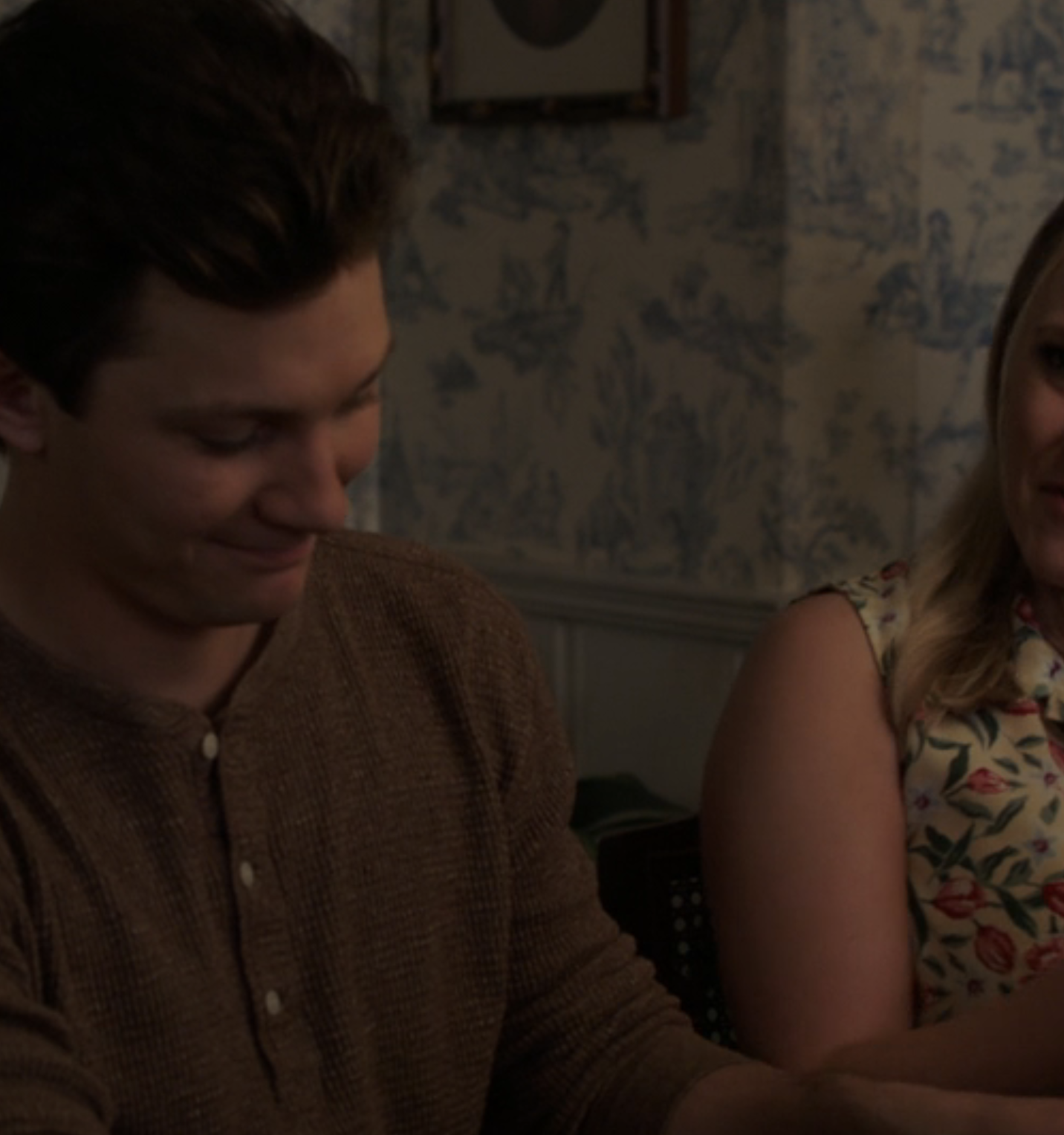 Mandy in a floral blouse at the dinner table