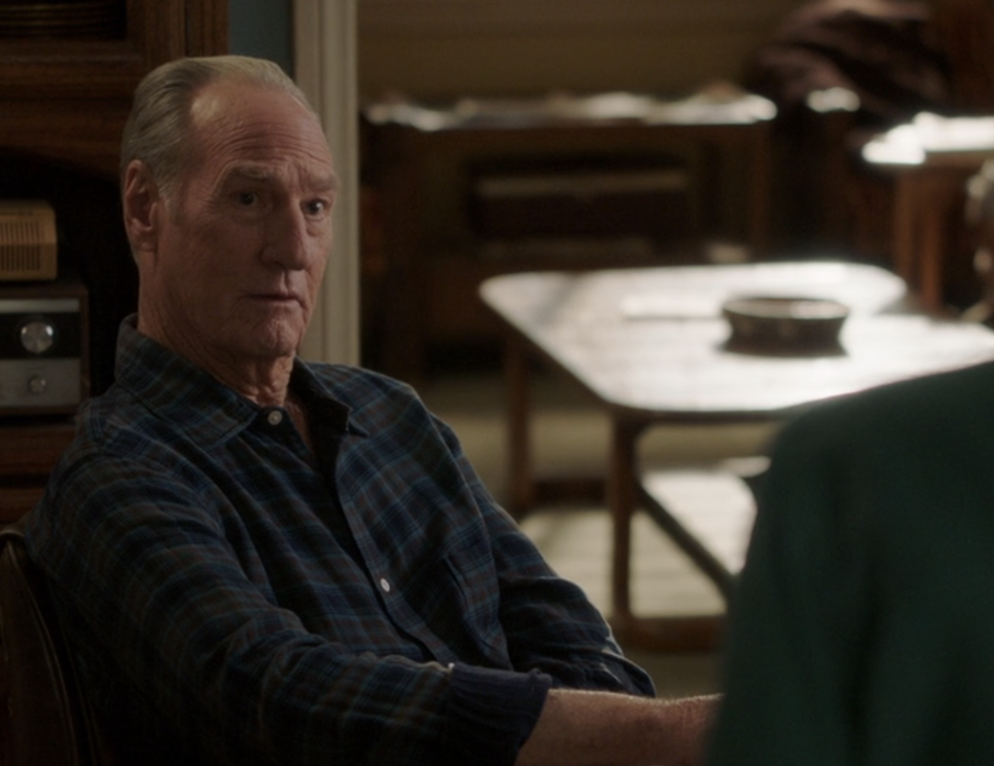 Dale in a plaid shirt sitting
