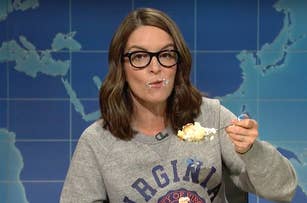 Tina Fey as character on SNL Weekend Update, eating cake and making a funny face