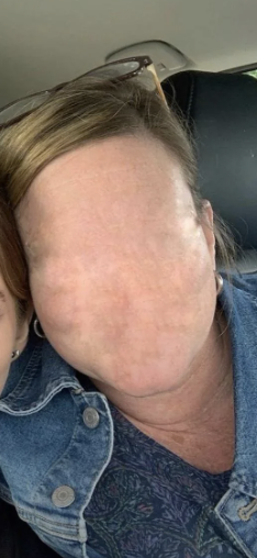 Two people in a selfie, one's face is obscured by their hair swept over, in a car