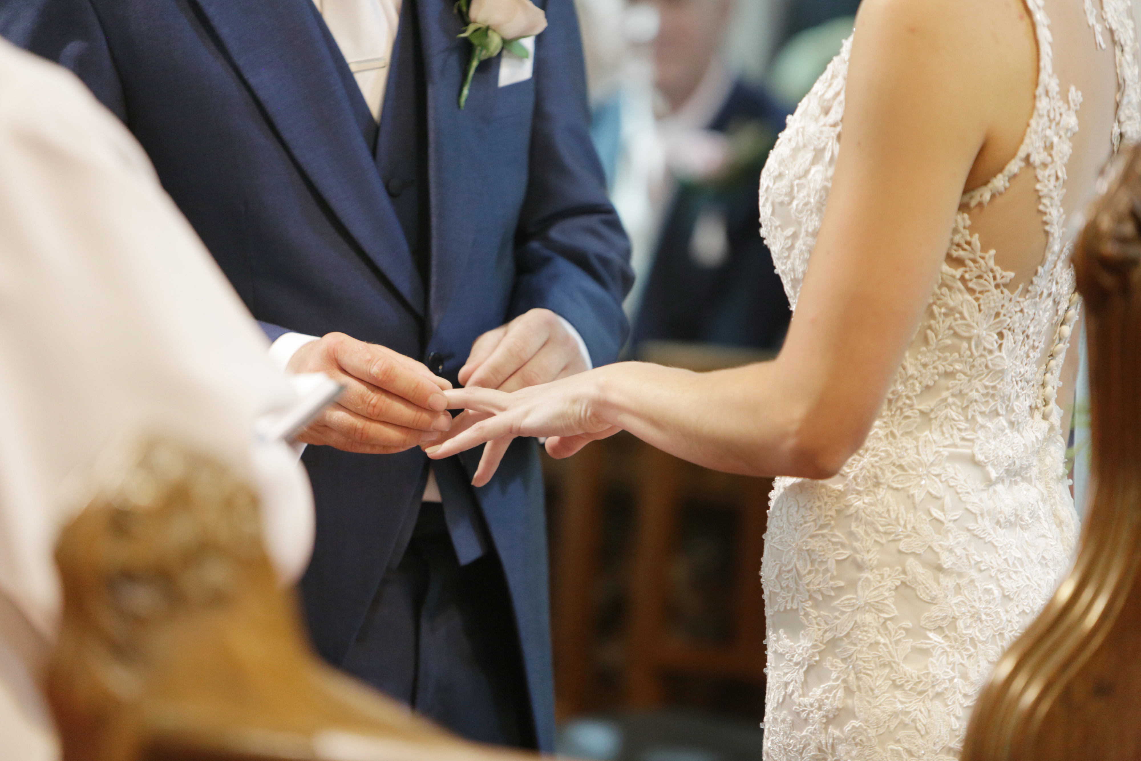 Bride and groom exchanging rings during wedding ceremony