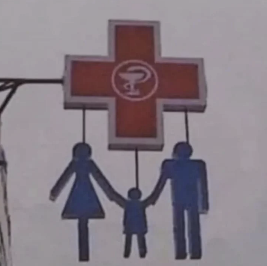 Sign with family figures holding hands under a pharmacy cross with a snake and cup symbol