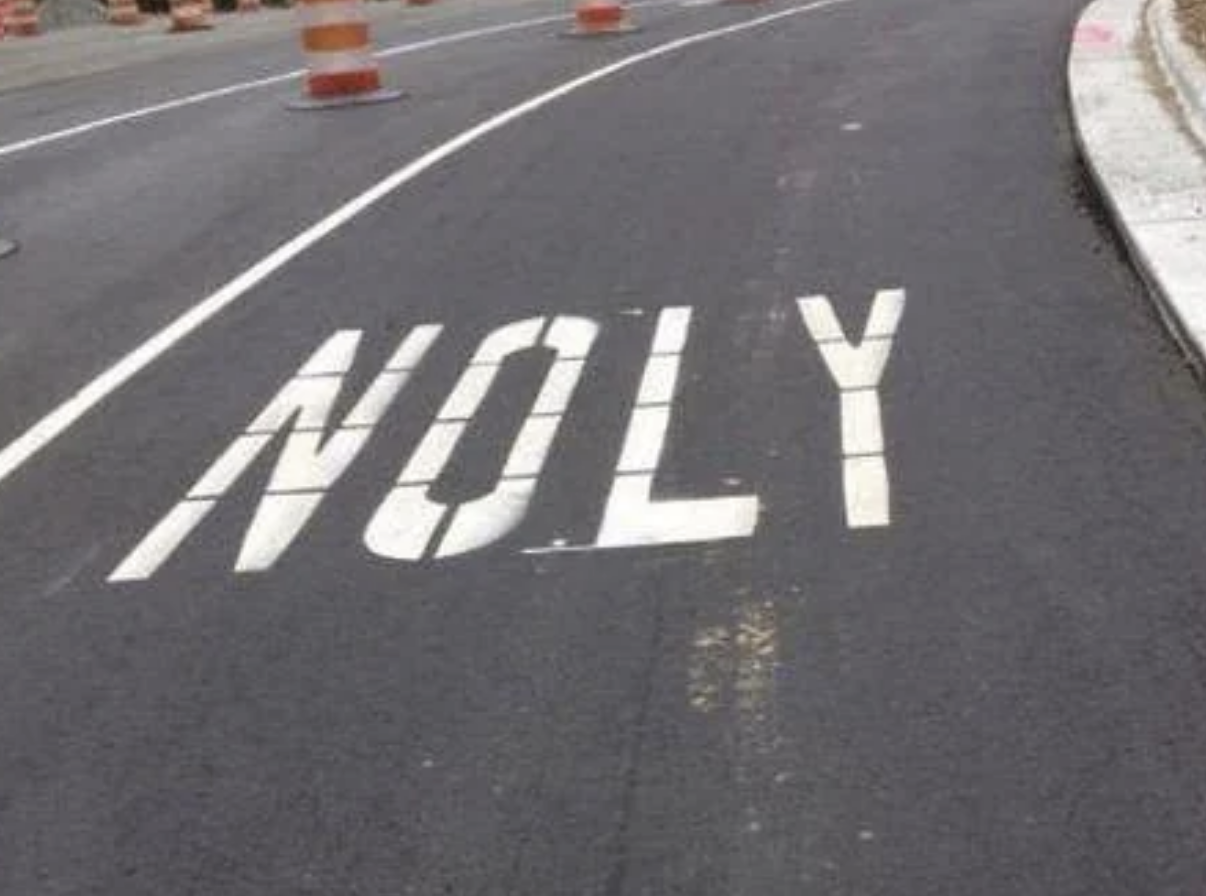 Road marking misspelled as &quot;NOLY&quot; instead of &quot;ONLY.&quot;