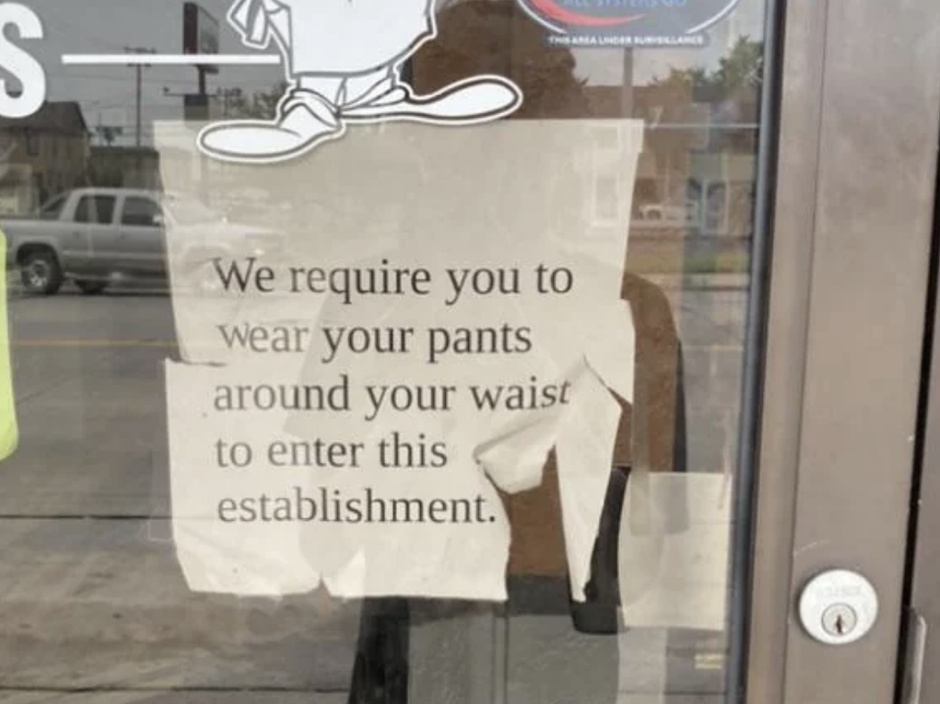 Sign on door reads &quot;We require you to wear your pants around your waist to enter this establishment.&quot;